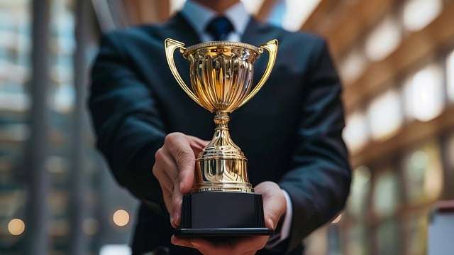 Person holding trophy – a visual reminder to reward yourself for small wins to stay motivated and achieve anything