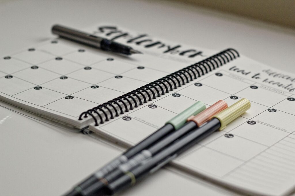 Planner and colored pens for daily planning prioritizaation