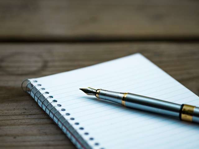 Notepad and pen to write down goals to help stop procrastination